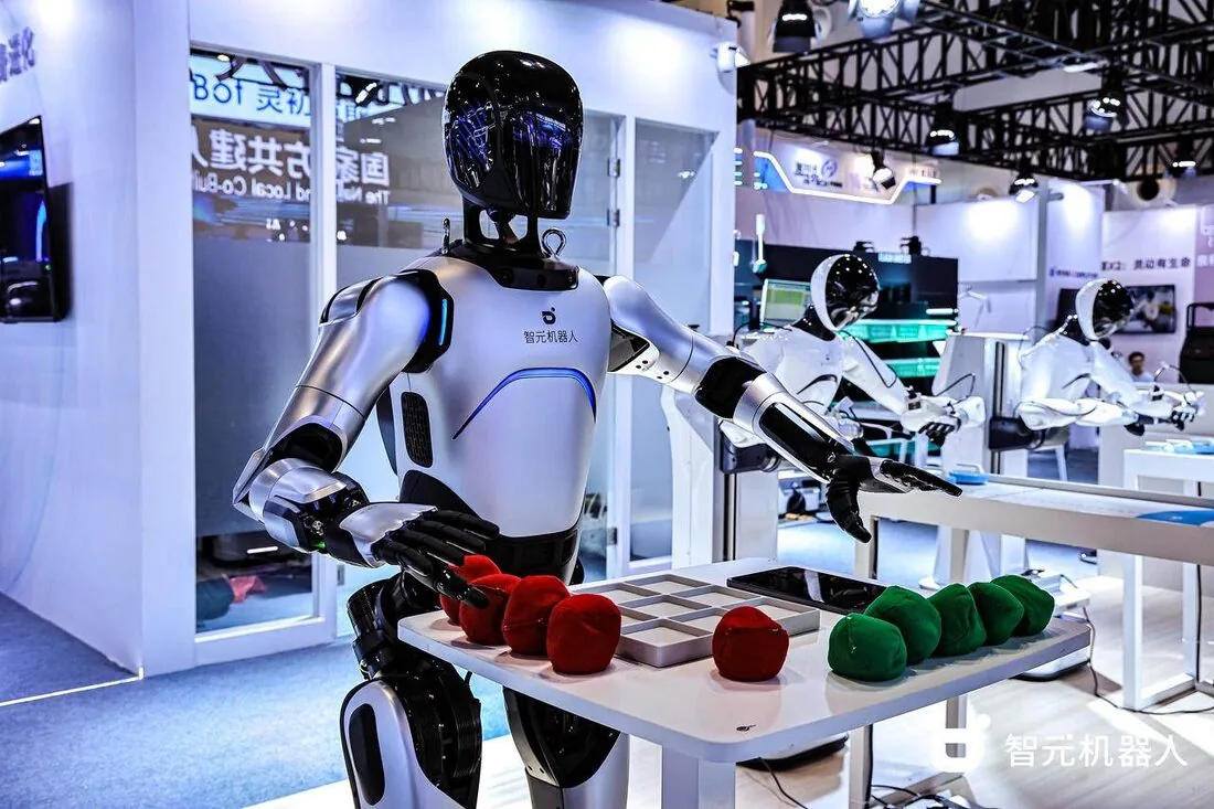 A2 Ultra performing a pick-and-place demo with colored objects on a table at a trade show booth